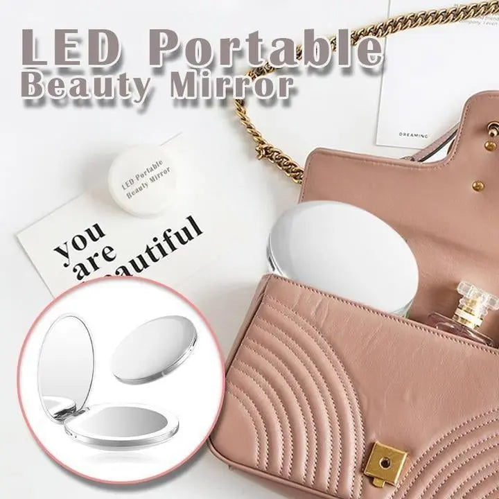 Rechargeable LED handheld makeup mirror from Health & Beauty-5 with illuminated reflective surface and sleek design.