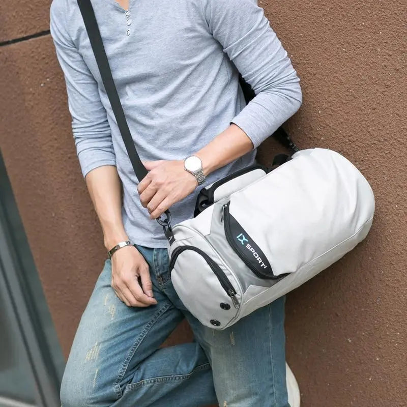 Men's gym and travel duffel bag by Fitness-6, showing durable black fabric with adjustable shoulder strap and multiple compartments.