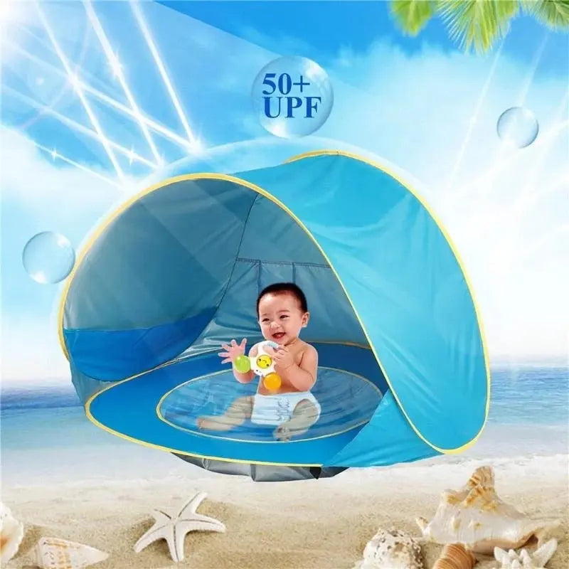 Small waterproof baby beach tent by Baby Essentials-4, pop-up design provides sun protection and shade for children at the beach.