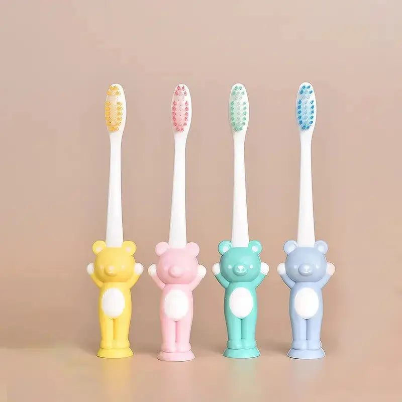Set of four Little Bear suction cup children's toothbrushes by Zenn Organics Inc with colorful handles for easy gripping.
