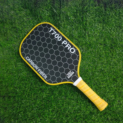Zenn Organics Inc LEATOU T700 pickleball paddle with carbon fiber surface and 16mm polypropylene honeycomb core, shown on a court.