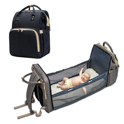 Baby Essentials-4 diaper bag with USB port and sleeping crib, shown with multiple compartments and adjustable straps for parents and babies.
