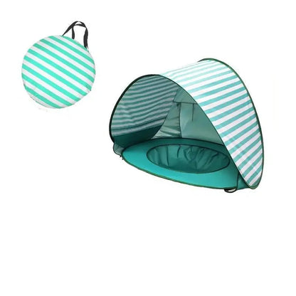 Waterproof Baby Beach Tent by Baby Essentials-4 set up on sandy beach, providing shade and protection for infants during outdoor activities.