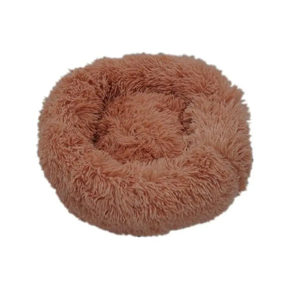 Pet Essentials-11 Calming donut bed for dogs and cats, soft round pet bed with plush fabric and cushioned edges for comfort.